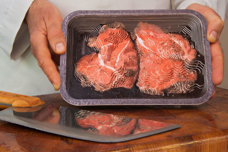 Photographic contour sculpture portraying two steaks in black foam tray, staged at the butcher's