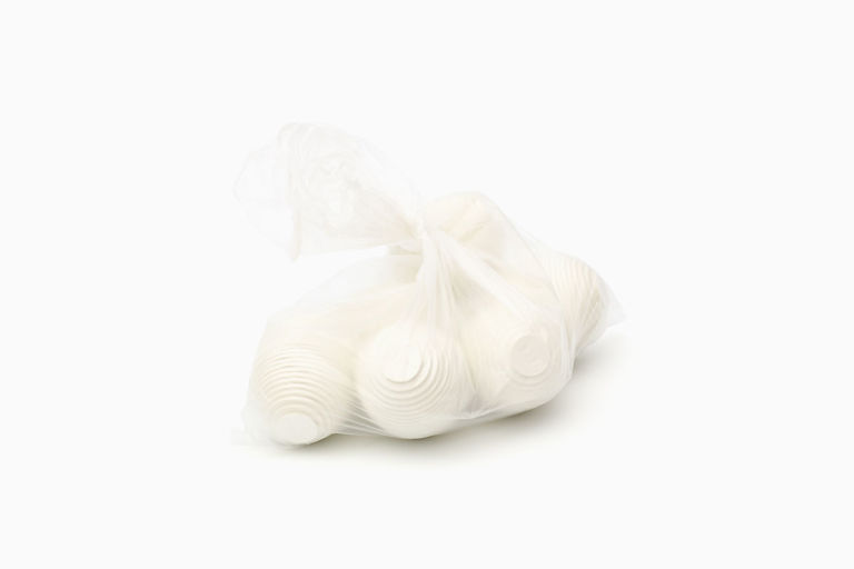 Limited edition print of six layered white cardboard eggs in a knotted clear plastic bag