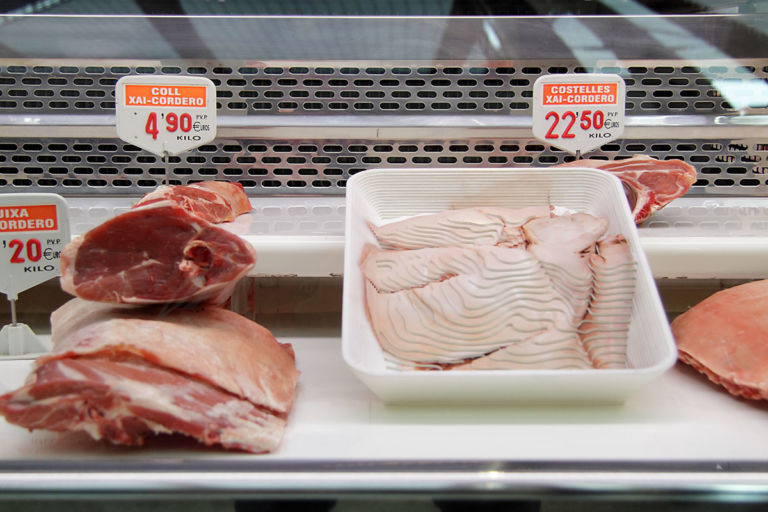 Photographic contour sculpture portraying a piglet in white foam tray, staged at the butcher's